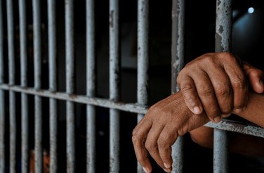 prisoners hands behind bars black 260nw 2689951365 1